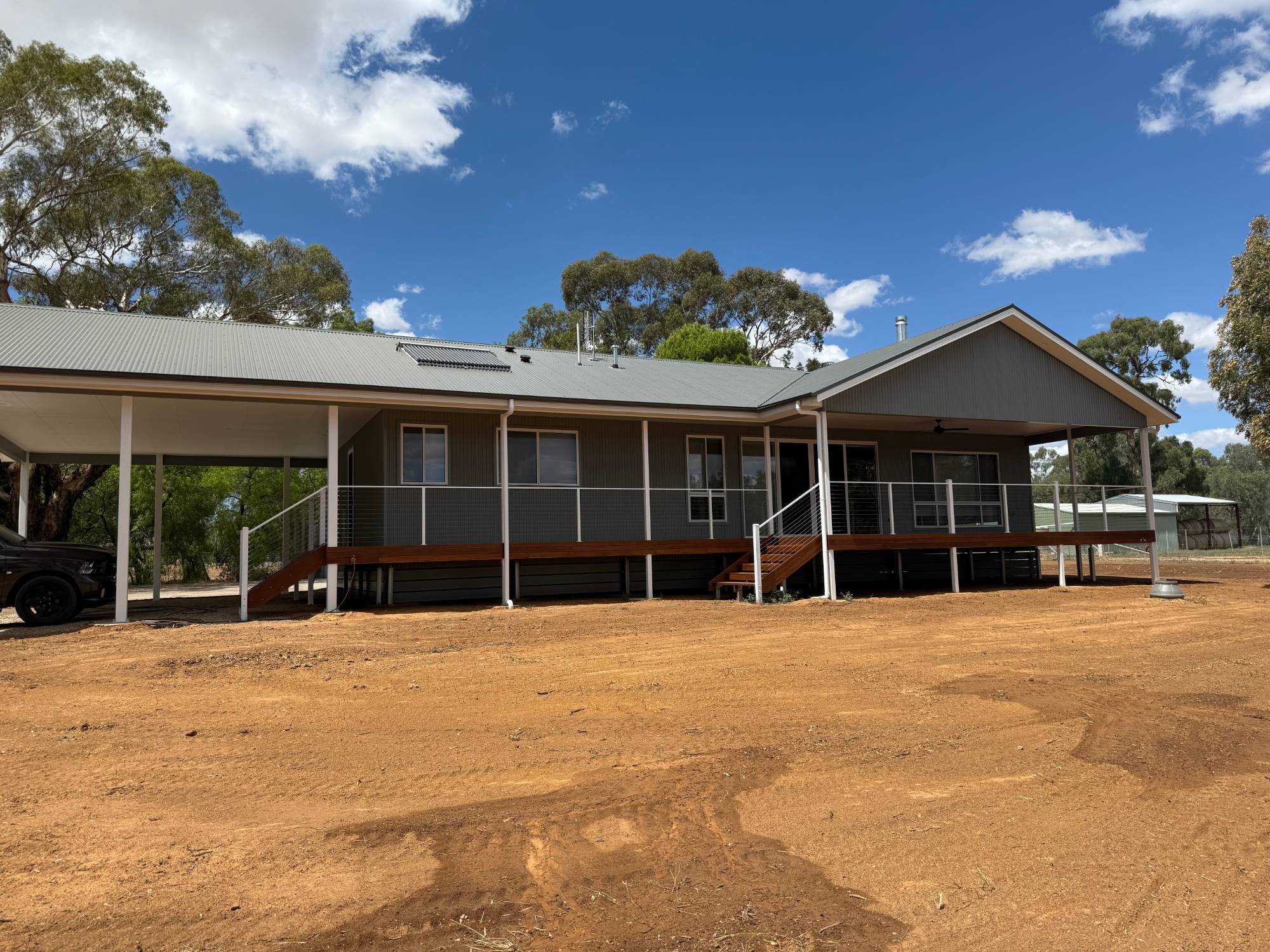 Rural home with wraparound hardwood deck and attached carport