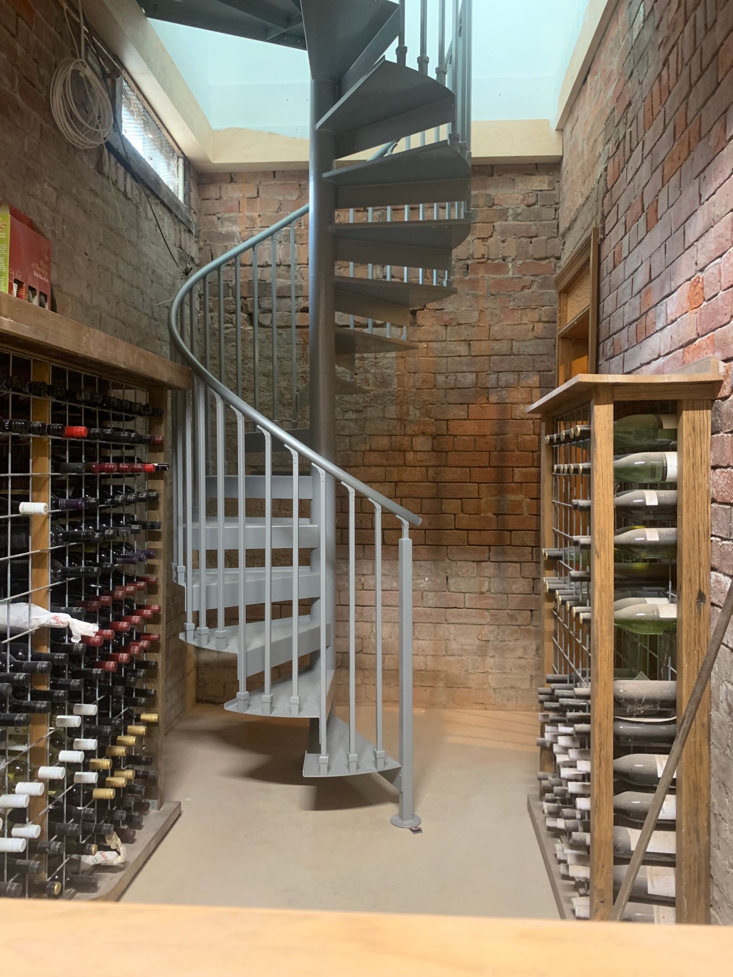 Brick wine cellar with spiral staircase